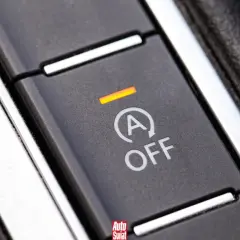 Przycisk systemu start-stop w samochodzie z napisem "A OFF" i pomarańczową kontrolką.