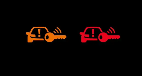 Pomarańczowa i czerwona kontrolka samochodu z kluczem Opel. Sygnalizuje problem z immobilizerem lub kluczykiem.